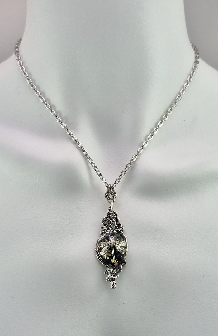 Sterling silver filled Victorian antique or reproduction work from original mold. The pendant features a silver floral design surrounding a central blue, green & gold antique Art Glass cabochon with a dragonfly motif.